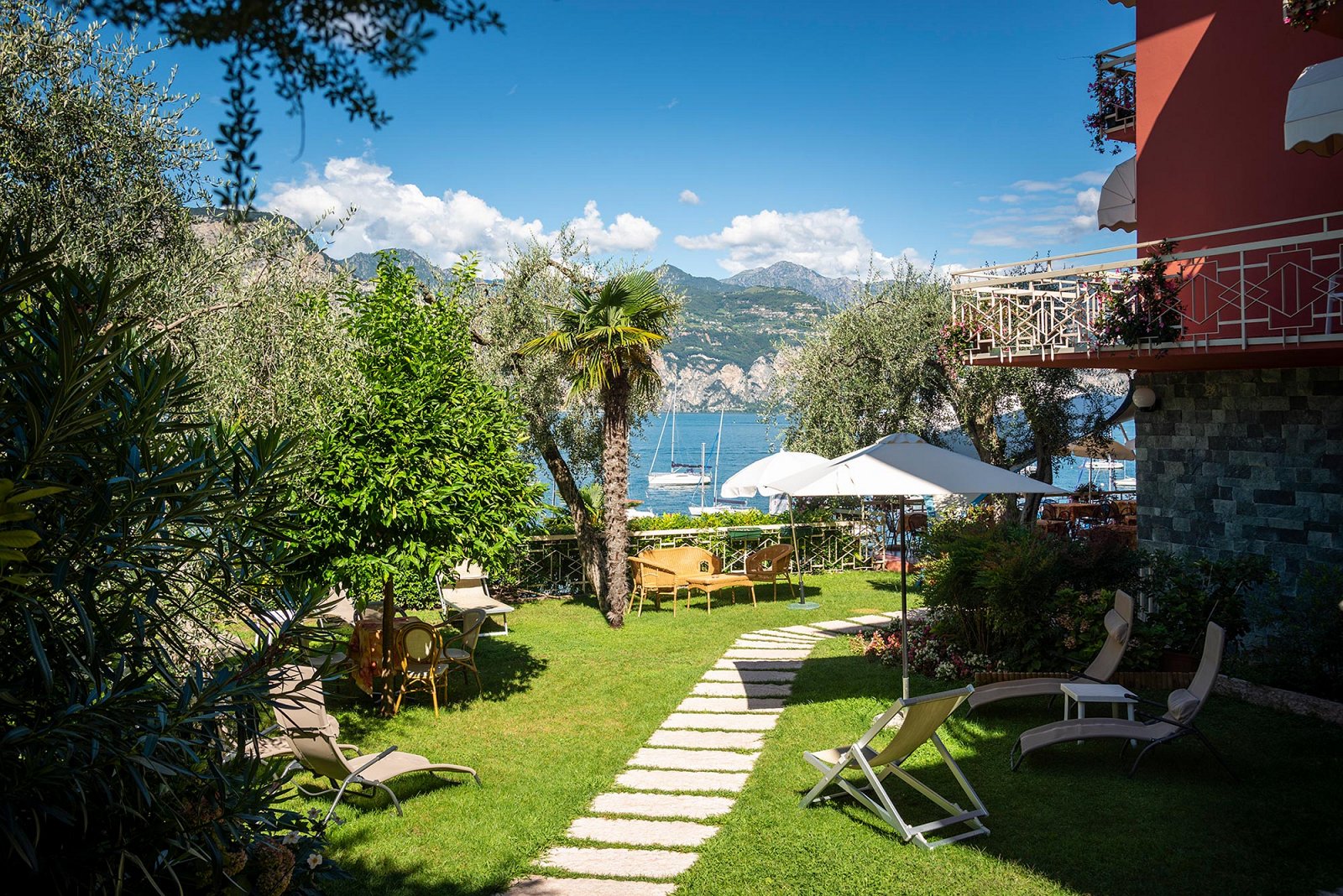 Giardino con lettini e tavolini dell'hotel 3 stelle Lago di Garda